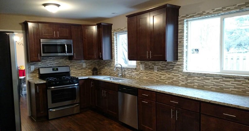 Image of granite countertops and tile backsplash installed by KPM for a kitchen remodel.